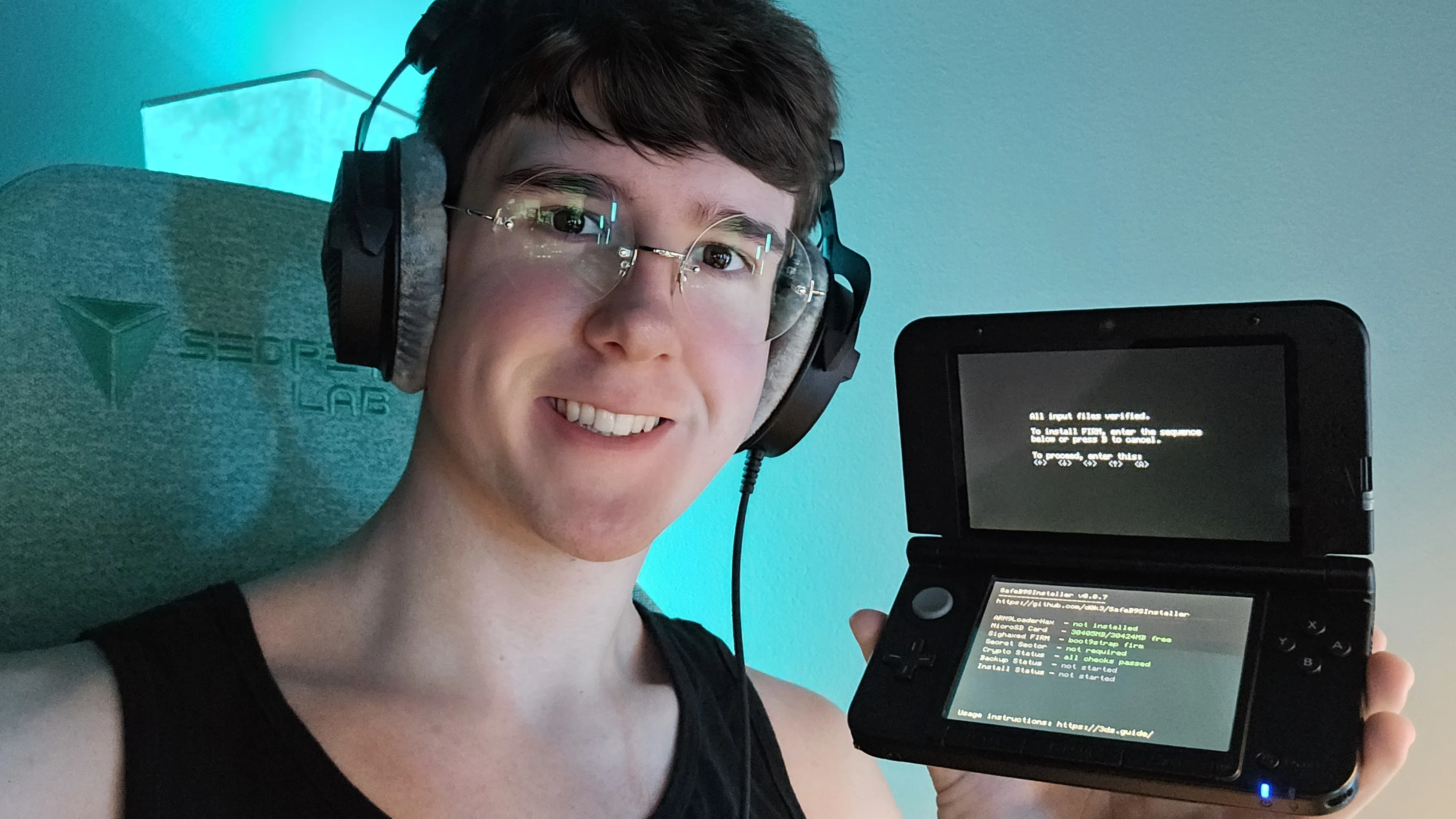 Portrait: smiling person holding a handheld console